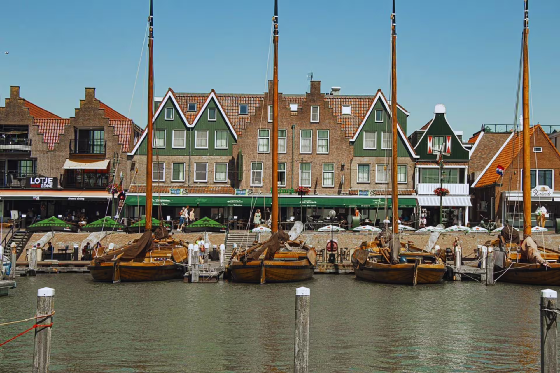 Volendam harbor waterfront with traditional Dutch houses and sailing boats, stop on Amsterdam countryside tour