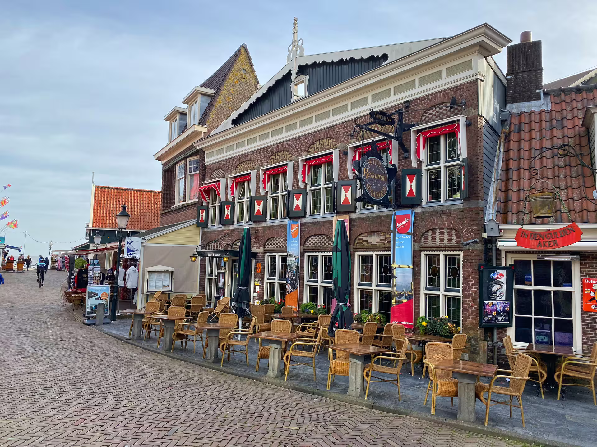 Volendam old town street with Dutch brick facades and terrace cafes, self-guided walking tour audioguide