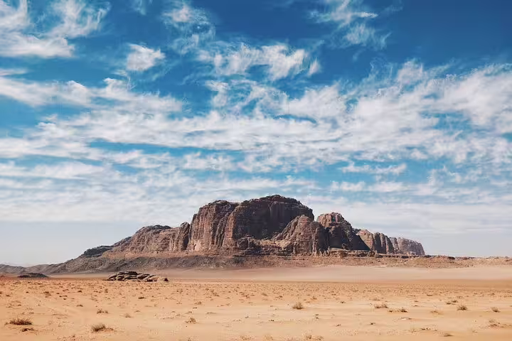 Wide Wadi Rum desert landscape under blue sky, day trip scenery on Petra tour from Taba by ferry boat