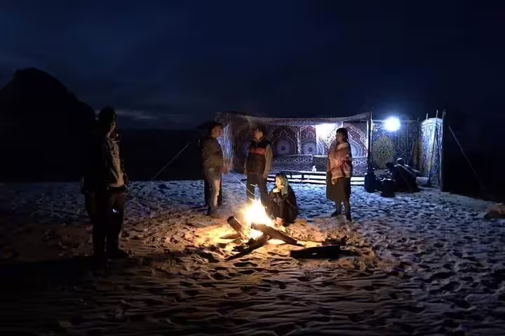 Night campfire in Egypt’s White Desert with Bedouin tent, part of a 3 days 2 nights Bahariya Oasis tour