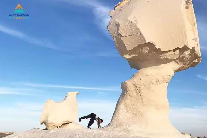 White Desert chalk rock formation and traveler, featured on 15-day Egypt itinerary to Pyramids Luxor Aswan Oasis