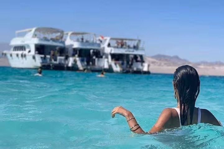 Swimmer in crystal-clear White Island lagoon near Ras Mohamed, Sharm El-Sheikh snorkeling boat trip