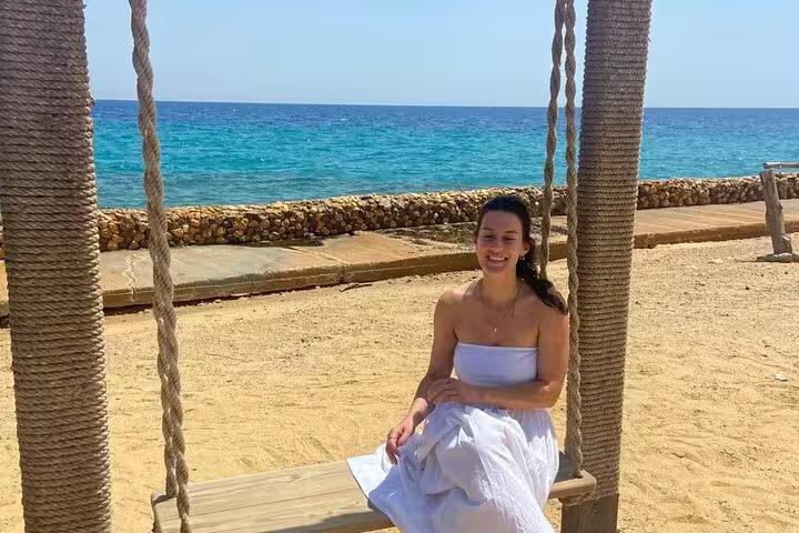 Woman relaxing on a beach swing by the Red Sea in Ain El Sokhna, ideal Cairo day tour seaside escape