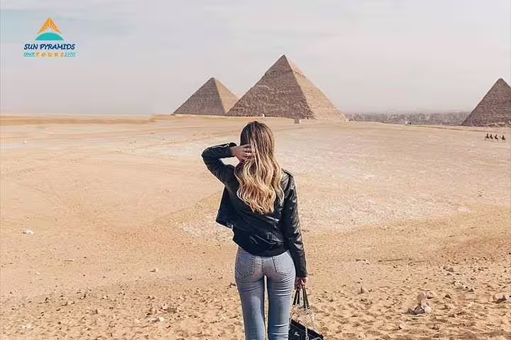 Woman overlooking Giza Pyramids desert panorama on Cairo luxury tour to pyramids, Saqqara, Memphis and Dahshur