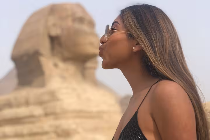Woman posing by the Great Sphinx on Hurghada to Cairo private tour, Giza Pyramids and Grand Egyptian Museum