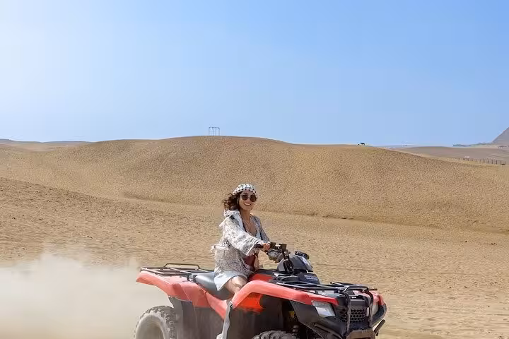 Woman driving a quad bike on Cairo desert dunes, an exciting ATV ride included in the Cairo day tour package