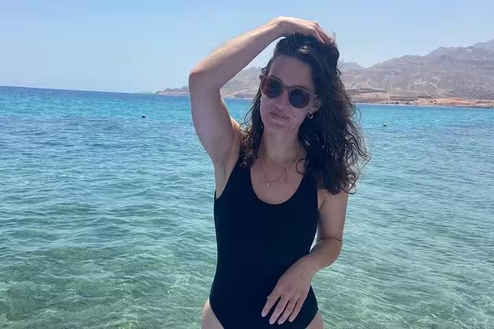 Woman posing in clear Red Sea water at Ain El Sokhna on a day trip from Cairo, Egypt coastal escape