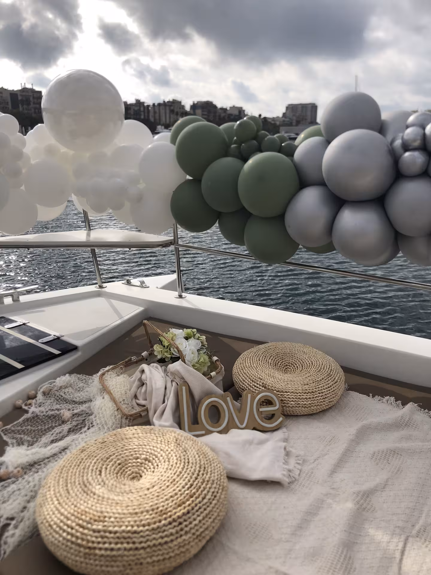 Yacht deck marriage proposal decor with balloon garland and love sign, romantic private cruise by the waterfront