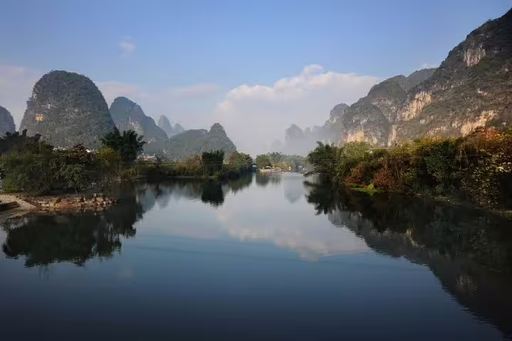 Serene view of the Li River reflecting karst mountains in Yangshuo, perfect for a private day tour and boat ride.