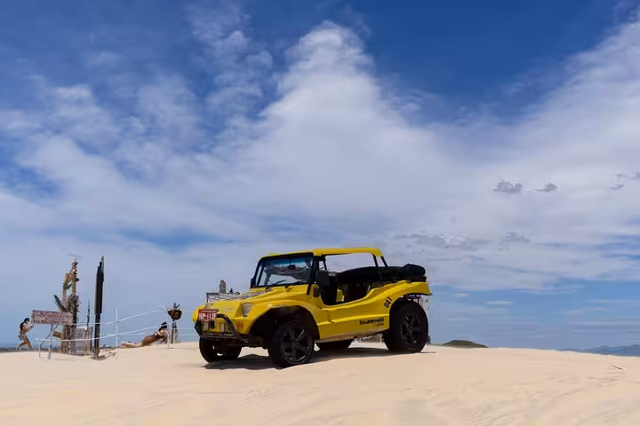 Yellow dune buggy on sandy dunes in Cumbuco, Ceará, ideal for Cumbuco Beach Tour adventure ride
