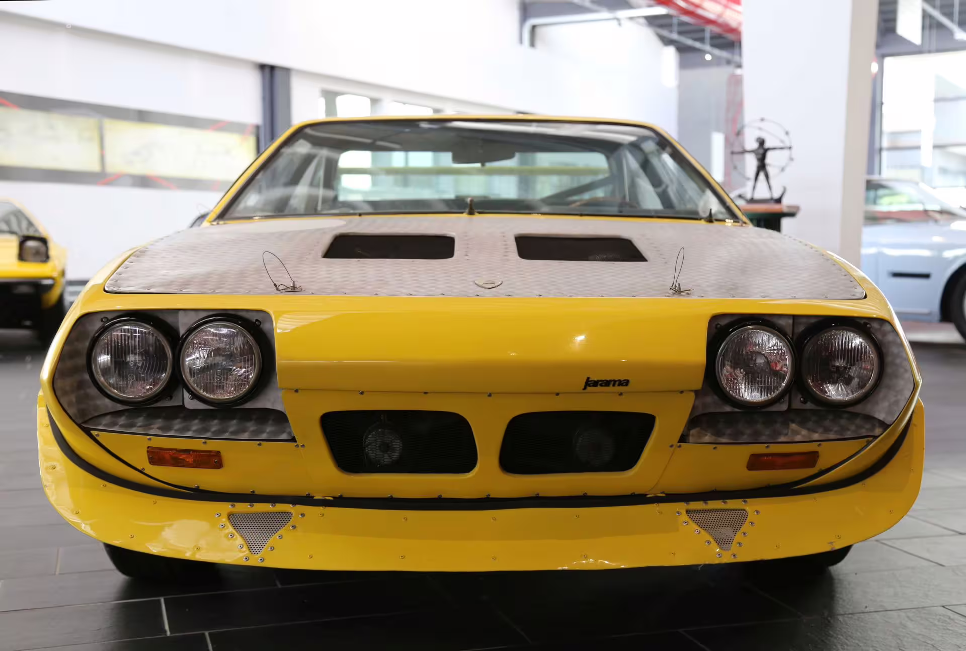 Front view of yellow Lamborghini Jarama on display at the Lamborghini Museum near Bologna, entry ticket tour