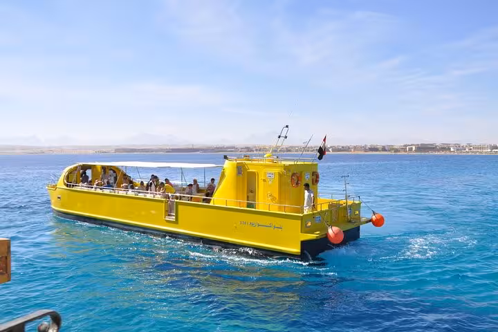 Bright yellow semi submarine boat sailing in El Gouna Red Sea, 2-hour sea trip departing from Abu Tig Marina