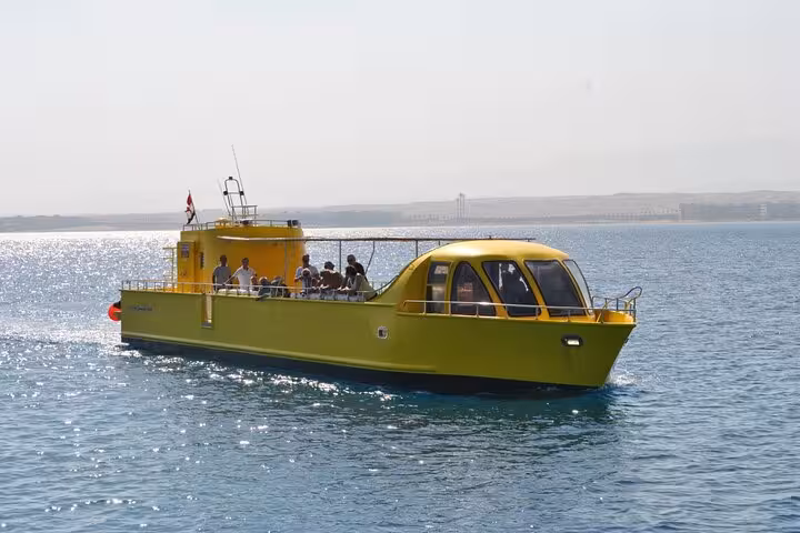 Yellow semi submarine boat cruising in El Gouna Red Sea on 2-hour sea trip departing Abu Tig Marina