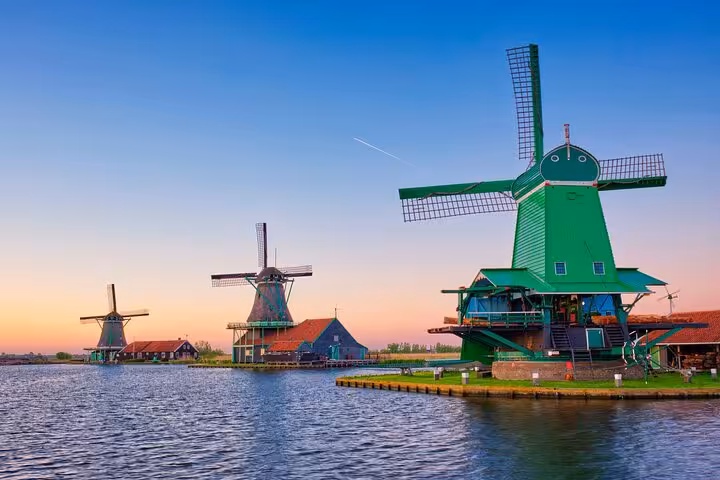 Zaanse Schans windmills at sunset near Amsterdam, classic Dutch countryside on Northern Highlights Tour
