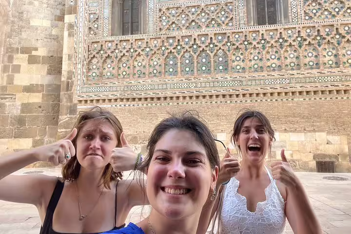 Friends selfie by Zaragoza Cathedral wall on a self-guided scavenger hunt tour exploring city sights