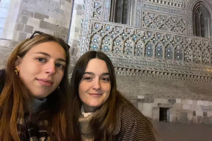Two travelers selfie at Zaragoza La Seo Cathedral facade during a self-guided scavenger hunt walking tour