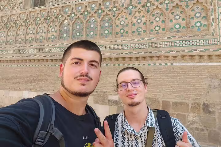 Friends pose by La Seo Cathedral mosaic wall on Zaragoza scavenger hunt self-guided sightseeing tour