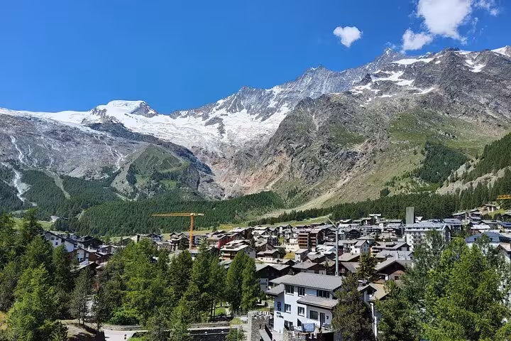 Zermatt village rooftops with glacier-capped Swiss Alps backdrop, highlight of 4-day Alps tour itinerary