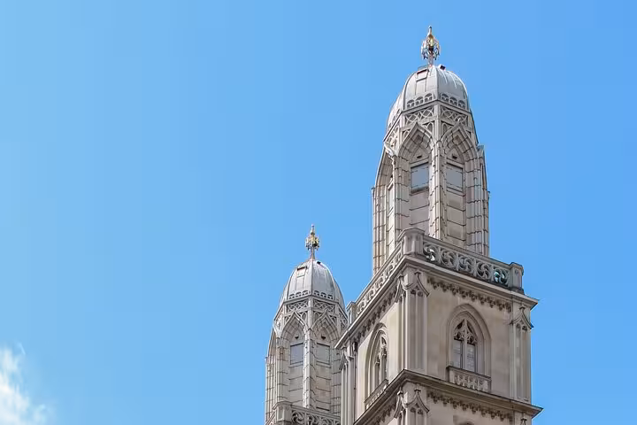 Close-up of Zurich's iconic Grossmünster towers against a clear blue sky, highlighting historic architecture.