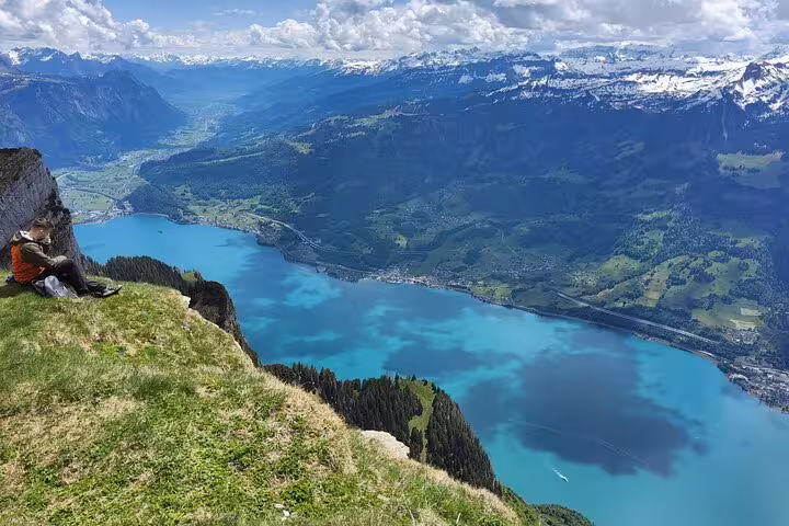 Solo hiker on Leistkamm Ridge overlooking Walensee and Swiss Alps on a guided day hike from Zurich