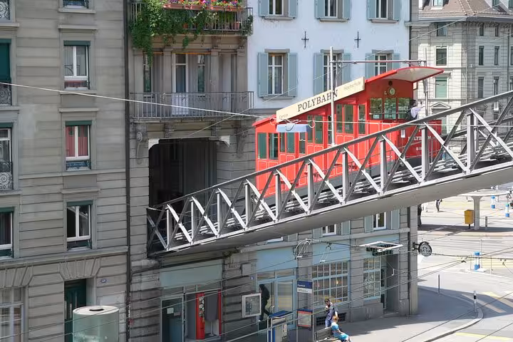 Historic red Polybahn funicular ascending in Zurich, offering a unique transportation experience on the adventure tour.