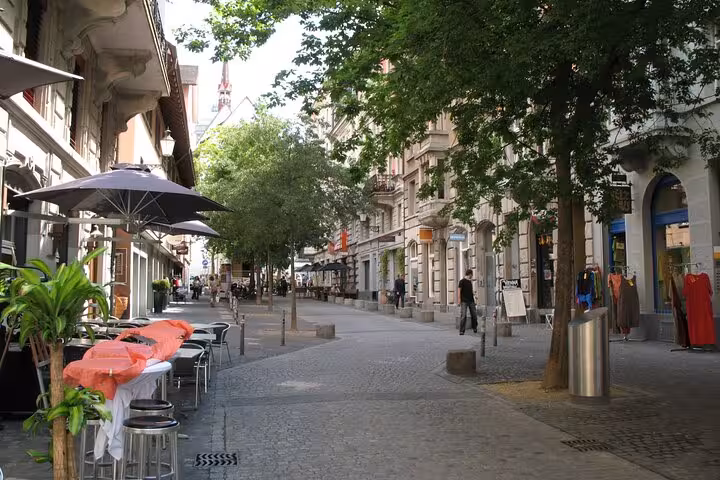 Charming Zurich street with outdoor cafes, perfect for a leisurely stroll on the Transportation Adventure tour.