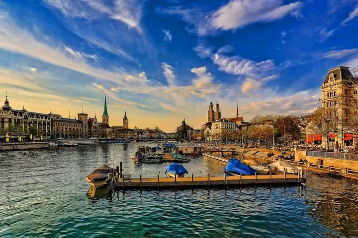 Scenic view of Zurich's waterfront with historic architecture, perfect for the Zurich Transportation Adventure tour.
