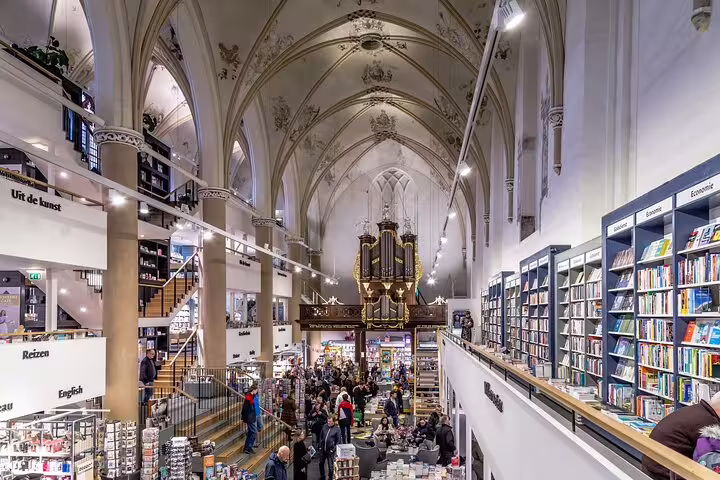 Bookstore inside Zwolle church with vaulted ceiling, ideal stop on walking tour with audio and GPS guide
