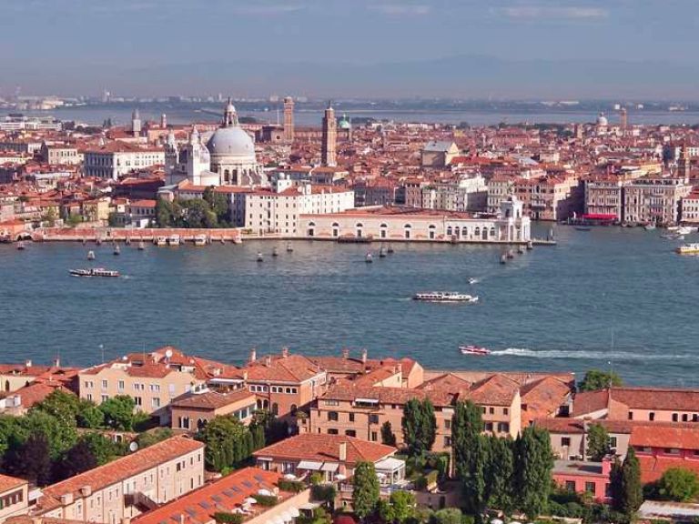 Giudecca, a serene island in Venetian Lagoon, lies south of the main Venice island. Connected by bridges like Ponte della Giudecca, it's a short distance from iconic Piazza San Marco.