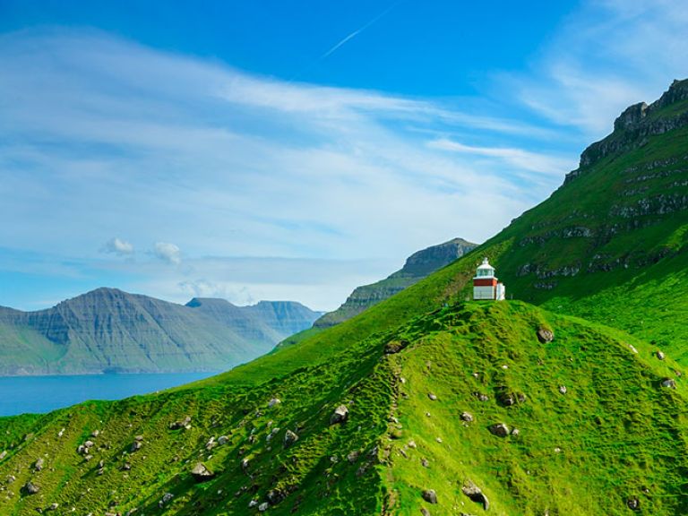 Attractions-in-Kalsoy-island: Kalsoy, a charming island in Denmark's autonomous Faroe Islands, is famed for its dramatic coastline, towering mountains, and verdant valleys. Located in the northern archipelago, it's accessible only by ferry from nearby Klaksvík.