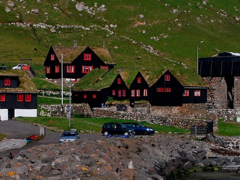 Attractions-in-Kirkjubøur: Kirkjubøur, a historic village on Streymoy in the Faroe Islands, is renowned for its natural beauty and rich cultural heritage. Its top attraction is the 14th-century Magnus Cathedral ruins.