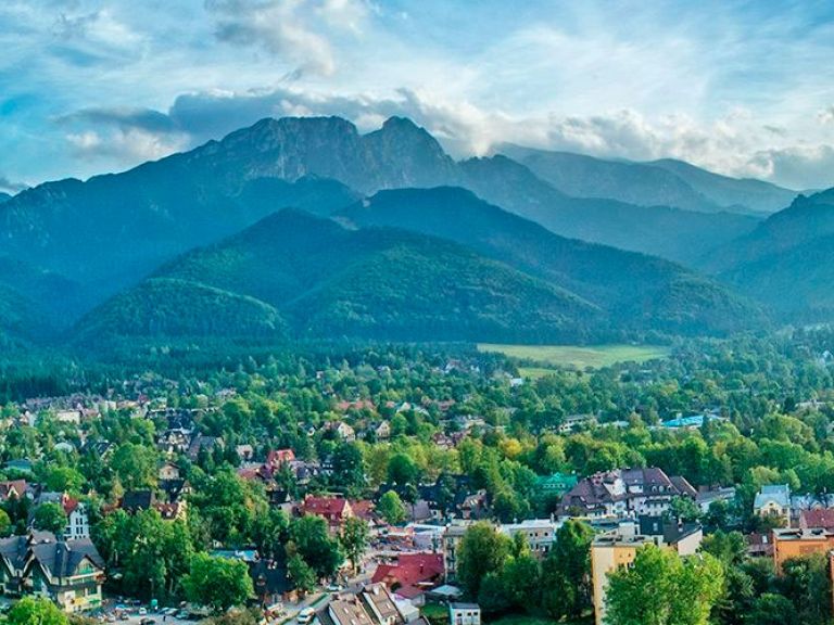 Attractions-in-Zakopane: Zakopane, nestled at the Tatra mountains' foothills, is a charming town with 30,000 inhabitants. Its unique location draws tourists for breathtaking views and outdoor pursuits like hiking, skiing, and mountain climbing. Embrace its traditional architecture and lively culture, featuring folk music and dance.