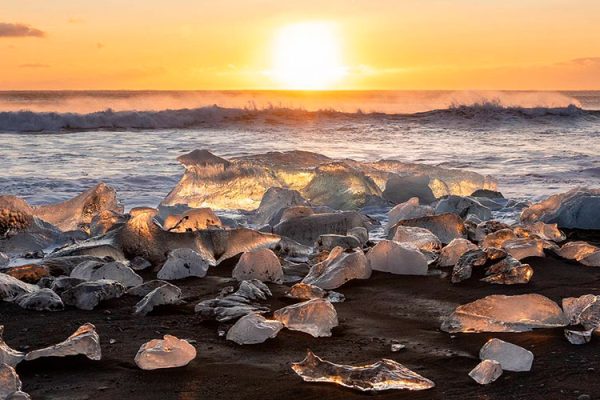 Diamond Beach, southeast Iceland near Hofn, boasts black sand and ice chunks from Jökulsárlón lagoon resembling blue-tinted diamonds, hence its name.