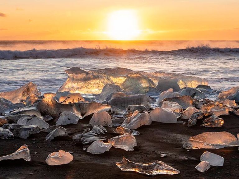 Diamond Beach, southeast Iceland near Hofn, boasts black sand and ice chunks from Jökulsárlón lagoon resembling blue-tinted diamonds, hence its name.