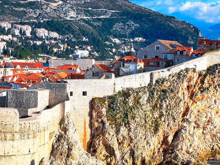 Discover Dubrovnik's Old City Walls, an iconic attraction with stunning Adriatic Sea views. Built in the 13th century, these historic walls defended the city from invasion and now surround the charming centre of Dubrovnik, Croatia.