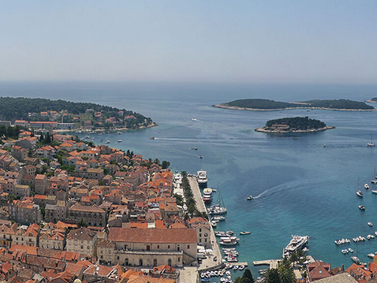 Hvar, the queen of Croatian Dalmatian islands, boasts mild climate, rich vegetation, and stunning beauty. With over 2,700 sunny hours yearly, it's dubbed the new St. Tropez. Experience a blend of natural beauty, history, and culture on this island paradise.