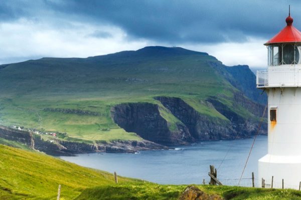 Established in 1927, Kallur Lighthouse graces Kalsoy's northern coast in the Faroe Islands. Perched on a dramatic cliff, this historic landmark offers breathtaking views of the rugged coastline, Atlantic Ocean, and neighboring islands.