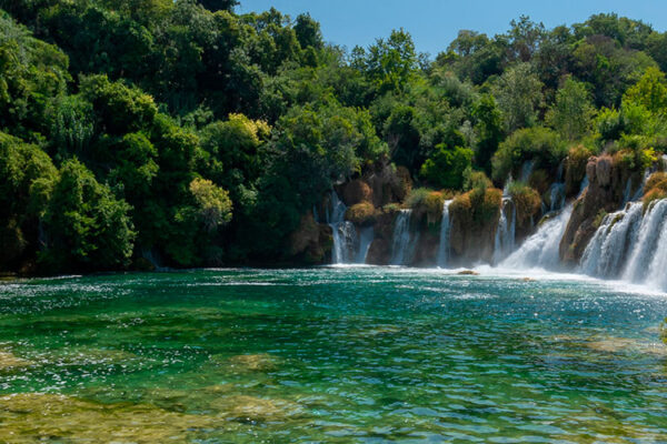 Discover Krka National Park, a Croatian gem established in 1985. Admire the breathtaking 242-meter-tall Skradinski buk waterfall and explore historical and cultural sites, attracting tourists and scholars alike.
