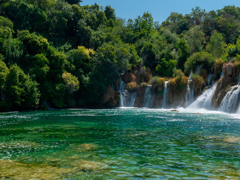 Discover Krka National Park, a Croatian gem established in 1985. Admire the breathtaking 242-meter-tall Skradinski buk waterfall and explore historical and cultural sites, attracting tourists and scholars alike.