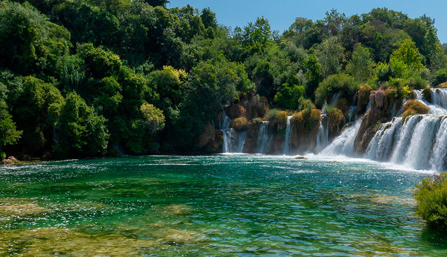 Discover Krka National Park, a Croatian gem established in 1985. Admire the breathtaking 242-meter-tall Skradinski buk waterfall and explore historical and cultural sites, attracting tourists and scholars alike.