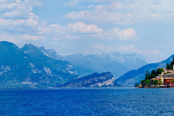 Italy's largest lake, Lake Garda, enchants visitors with picturesque towns, mountainous backdrops, and opportunities for outdoor adventures. Known for its wine, particularly Bardolino, the region serves up delightful cuisine including fresh seafood and homemade pasta.