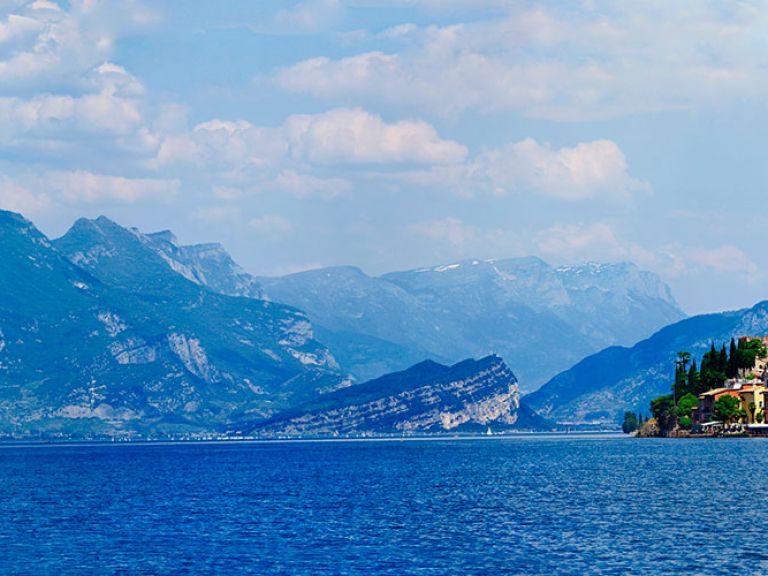 Italy's largest lake, Lake Garda, enchants visitors with picturesque towns, mountainous backdrops, and opportunities for outdoor adventures. Known for its wine, particularly Bardolino, the region serves up delightful cuisine including fresh seafood and homemade pasta.