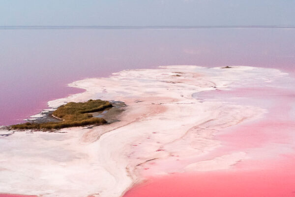 Las Coloradas, Mexico's pink lakes, reside in the Yucatan Peninsula. Comprising three natural lagoons, they owe their hue to Dunaliella salina algae, which blooms in abundance, creating a stunning pink spectacle.