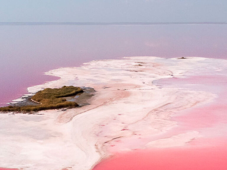 Las Coloradas, Mexico's pink lakes, reside in the Yucatan Peninsula. Comprising three natural lagoons, they owe their hue to Dunaliella salina algae, which blooms in abundance, creating a stunning pink spectacle.
