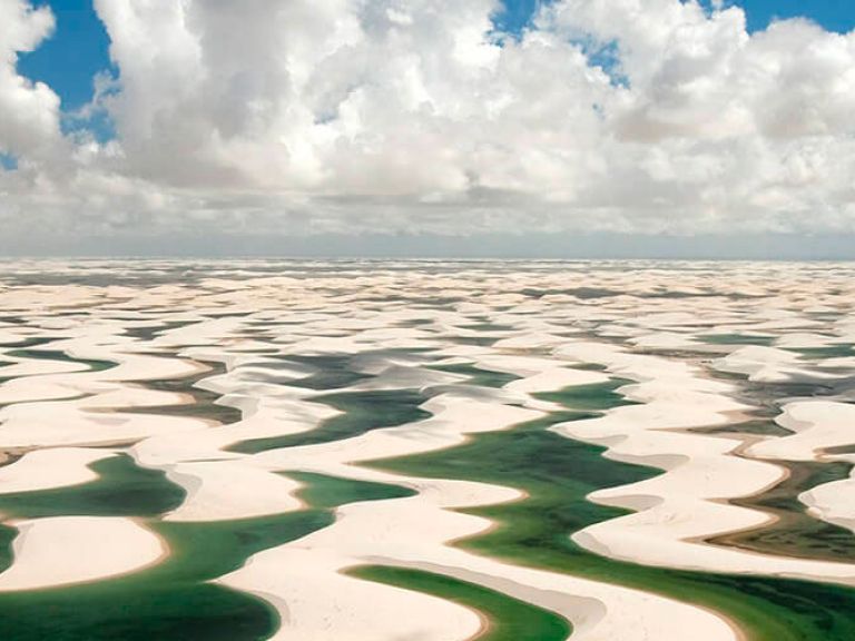 Lençóis Maranhenses National Park in Brazil is famous for its vast sand dunes and crystal-clear lagoons that form in the rainy season.