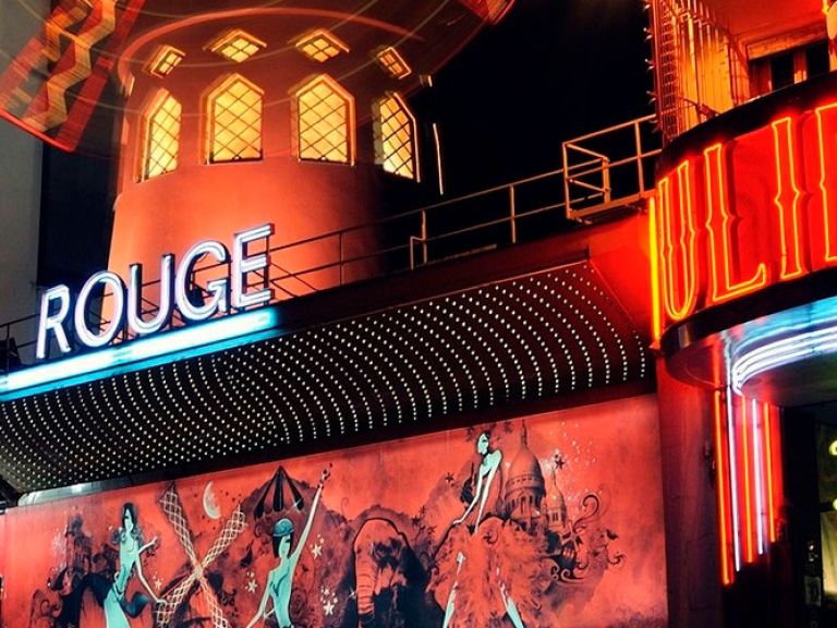 Located in Paris's Montmartre district, the world-famous Moulin Rouge cabaret, established in 1889, boasts extravagant shows and a vibrant atmosphere, making it a must-visit symbol of Parisian culture for global tourists.