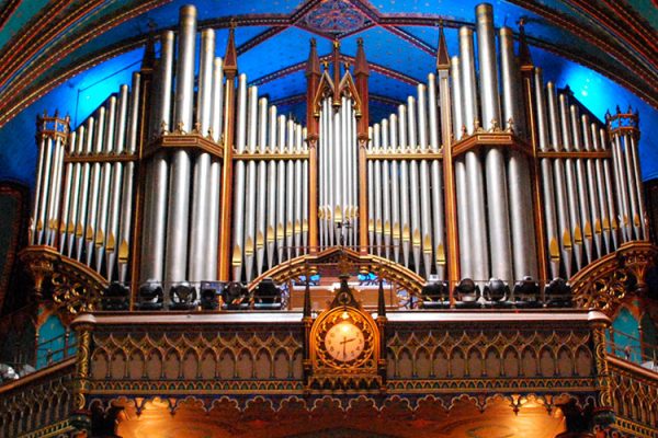 Discover Montreal's Notre-Dame Basilica, a stunning Gothic Revival masterpiece in Old Montreal. Its intricate interior, highlighted by a mesmerizing rose window and impressive pipe organ, creates an enchanting experience for visitors.