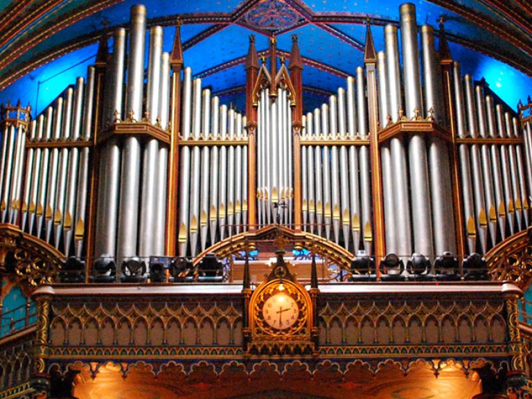 Discover Montreal's Notre-Dame Basilica, a stunning Gothic Revival masterpiece in Old Montreal. Its intricate interior, highlighted by a mesmerizing rose window and impressive pipe organ, creates an enchanting experience for visitors.