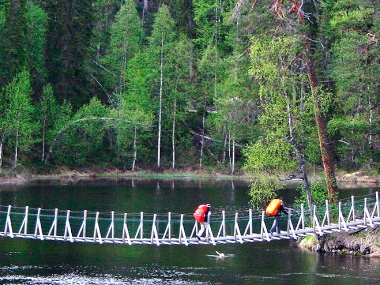 Located near Russia in Finland's Pohjois-Karjala region, Oulanka National Park boasts stunning forests, rivers, and waterfalls across 80 square kilometers. It offers diverse wildlife, hiking trails, and outdoor activities like canoeing and skiing.