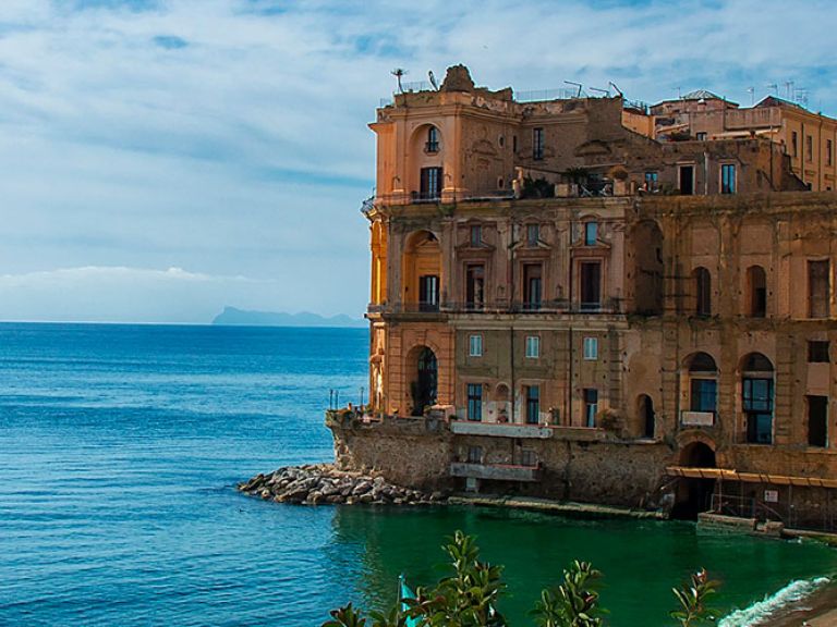Palazzo Donn'Anna is a beautiful and historic building located in the Posillipo neighborhood of Naples, Italy. This stunning palace was built in the 17th century as a private residence for the noblewoman Anna Carafa, and is considered one of the most beautiful and important examples of Baroque architecture in the city.
